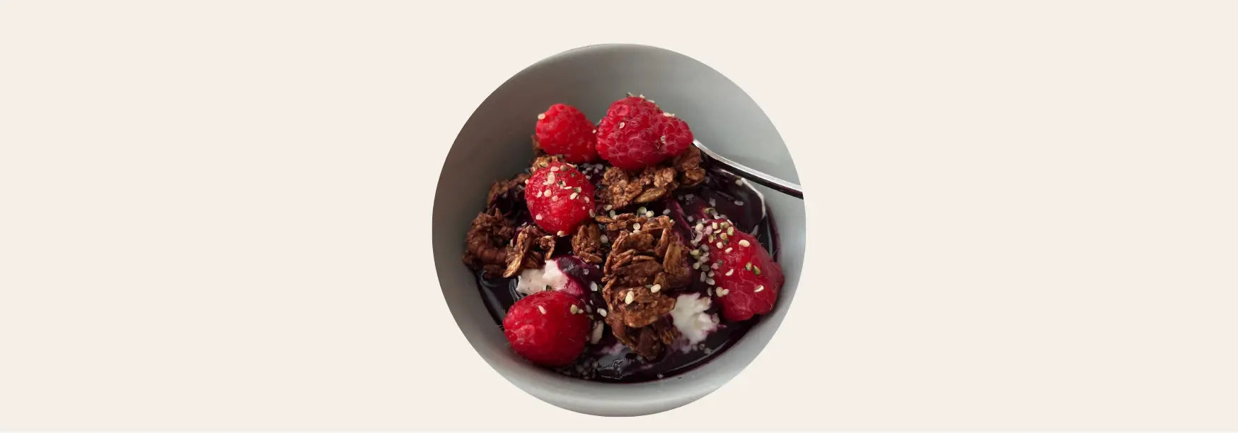 Yogurt bowl with granola, raspberries, and NOORA Immunity